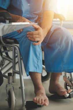 young asian physical therapist working with senior woman on walking with a walker