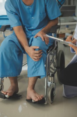 young asian physical therapist working with senior woman on walking with a walker