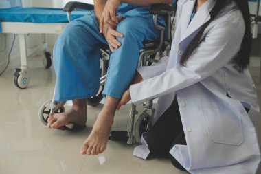 young asian physical therapist working with senior woman on walking with a walker
