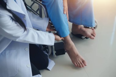 young asian physical therapist working with senior woman on walking with a walker clipart