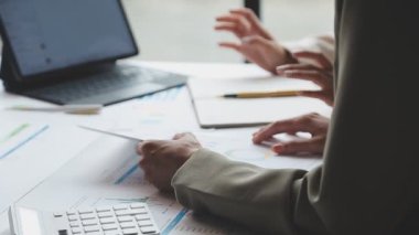 İş adamları finansal verileri tartışıyor ve finansal tabloları analiz ediyor