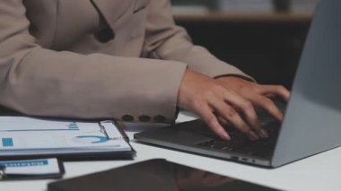 Ofiste çalışan dizüstü bilgisayarlı bir iş kadını.