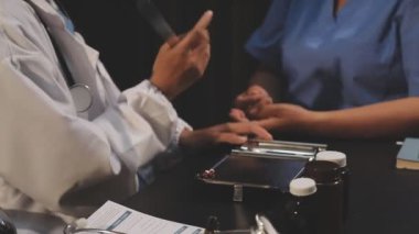 Doktor eli hasta için tablet kullanıyor.