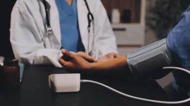 Doktor hastanede kan basıncını ölçüyor.