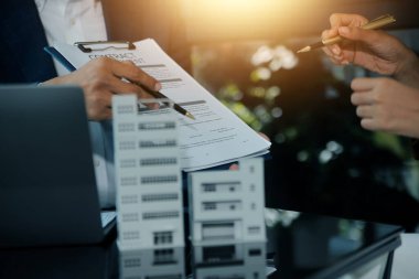 Emlakçı ve müşteri ev, sigorta ya da emlak satın almak için sözleşme imzalarlar. Ev kiralarlar, sigorta yaptırırlar, emlak veya emlak kredisi alırlar..