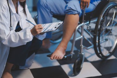 Asyalı, genç, profesyonel, dost canlısı mavi hastane üniformalı kadın hemşire yaşlı, yaşlı, sağlıksız, dört bacaklı, yürüyen bir hastanın fiziksel terapisine yardım ediyor..