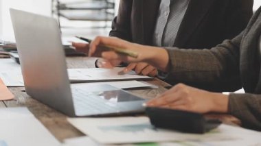 Bilgisayarlı bir iş kadını iş ortağıyla aynı masada çalışıyor.