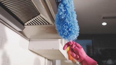 Mavi lastik eldivenle evi temizliyor..