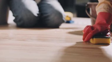 Yerleri fırça ve bezle temizleyen bir kadın.