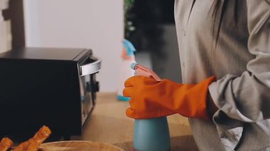 Mutfaktaki masayı paçavrayla temizleyen kadın ellerini kapat.