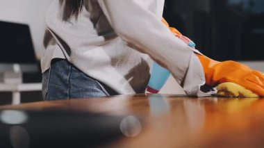 Masayı mutfak örtüsü ve sprey şişeyle temizlemek, temizlik servisi konsepti, lastik eldivenli bir adam..