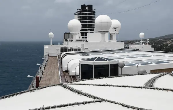 A cutting-edge satellite system perched atop a cruise ship, a beacon of connectivity navigating the open seas.