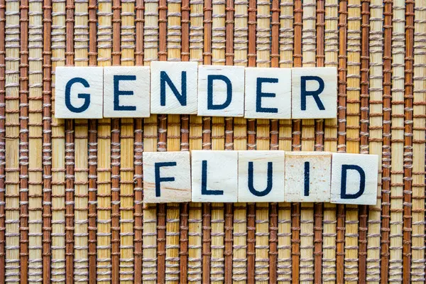 Gender Fluid concept word in wooden letters on straw mat background