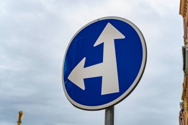 Directional road sign indicating multiple routes for vehicles at an intersection in Czechia during cloudy weather clipart