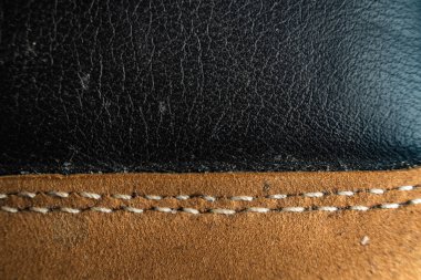 Ayrıntılı ayakkabı malzemesinin yakın görüntüsü tarafsız bir arkaplan ile dikişleri ve dokuyu gösteriyor
