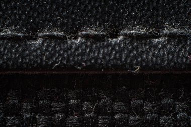 Close-up view of textured black fabric showcasing intricate weave patterns and soft fibers clipart