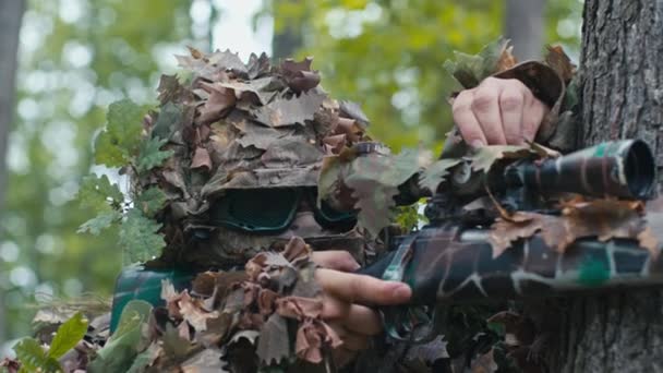 Camouflaged Sniper Tree Takes Aim High Precision Scope Distant Target — Stock Video