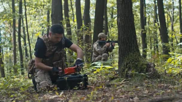 Soldato Prepara Drone Volo Mentre Suo Collega Guardia Nella Foresta — Video Stock