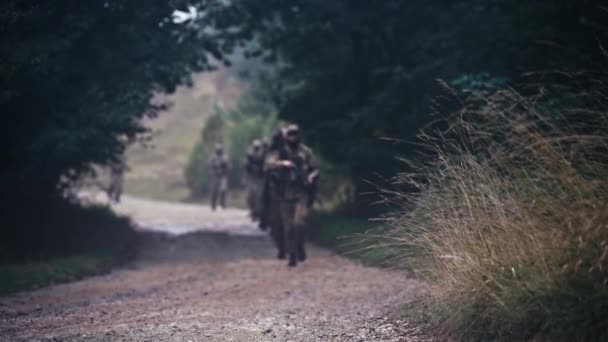 Military Unit Marches Line Macadam Defocused Shot Troops Display Discipline — Stock Video