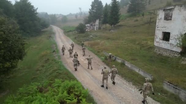 Aerial View Military Squad Walking Casually Dirt Road Next Destroyed — Stock Video