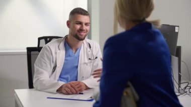 Gülümseyen doktor, parlak bir muayenehanedeki hastasına sıcak ve profesyonelce veda ediyor. Hasta-doktor ilişkisi ve sağlık hizmetleri kavramı