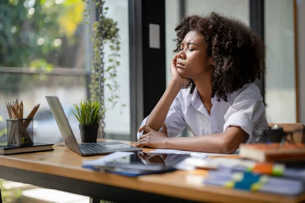 Businesswoman sitting stressed out analyzing work from laptop screen. thinking work concept.  Stress and overthinking during planning.	