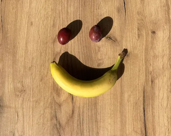 Smile. Top view of a banana on the wooden table. Culinary Concept