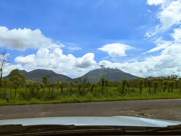 Arenal Volkanı, La Fortuna, Kosta Rika. La Fortuna, Kosta Rika 'daki zirveyi çevreleyen bulutlu Arenal Volkanı. Yeşil yapraklar ve tropikal ormanlar.