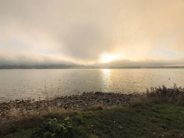 Rutland su gölü gölünün kışın gün batımında havadan görünüşü. Yoğun sis bulutları güneşi engelliyor ama kışın çok güzel renkler sağlıyor. Buzlu koşullar.