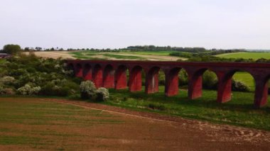 İngiltere 'de parlak ama puslu bir günde Twyford viyadük etrafında uçan hava manzaralı 4k. Sinematik.