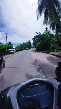 Point of view riding on a scooter motorbike in the Philippines, tropical landscapes and Asian roads, travelling backpacking holiday vacation footage 