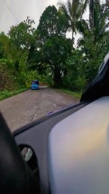Point of view riding on a scooter motorbike in the Philippines, tropical landscapes and Asian roads, travelling backpacking holiday vacation footage 