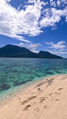 Point of view perspective of tropical beach, clear blue waters and white sand, Asian Philippines White island Camiguin, vacation holiday tourism 