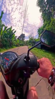 Point of view riding on a scooter motorbike in the Philippines, tropical landscapes and Asian roads, travelling backpacking holiday vacation footage 