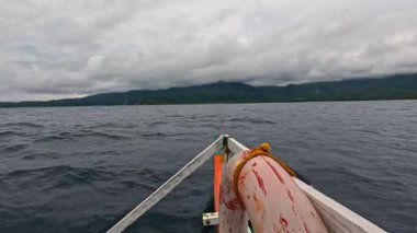 Point of view riding on Bangka Boat, water ferry, fishing vessel in Asia, Philippines, tropical landscapes and clear blue waters, vacation, backpacking, holiday tourism