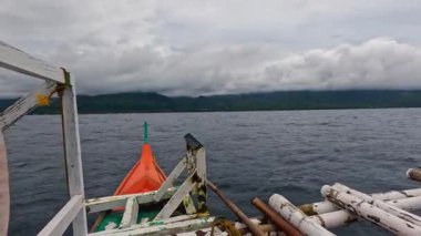 Point of view riding on Bangka Boat, water ferry, fishing vessel in Asia, Philippines, tropical landscapes and clear blue waters, vacation, backpacking, holiday tourism