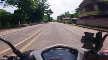 Point of view riding on a scooter motorbike in the Philippines, tropical landscapes and Asian roads, travelling backpacking holiday vacation footage 