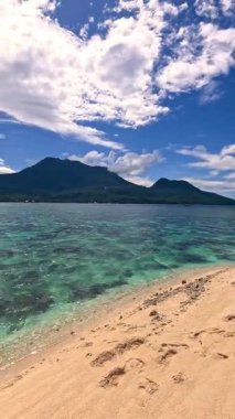 Point of view perspective of tropical beach, clear blue waters and white sand, Asian Philippines White island Camiguin, vacation holiday tourism 
