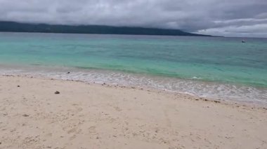Point of view walking around tropical sandbar island, Mantique Island, Camiguin, clear blue waters and white sandy beaches, Asia, Philippines, travel backpacking holiday tourism vacation 