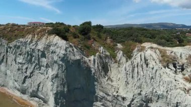 XI plajındaki kil uçurumların hava aracı görüntüsü, spa tedavisi ünlü konum, cilt mineralleri, temiz mavi su ve dik dağlar, Kefalonia Yunanistan Avrupa tatil beldesi turizmi 