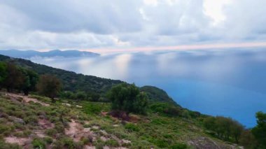 High footage of Myrtos beach and Ionian sea Kefalonia: vibrant blue water, white pebble arc, dramatic mountain cliffs