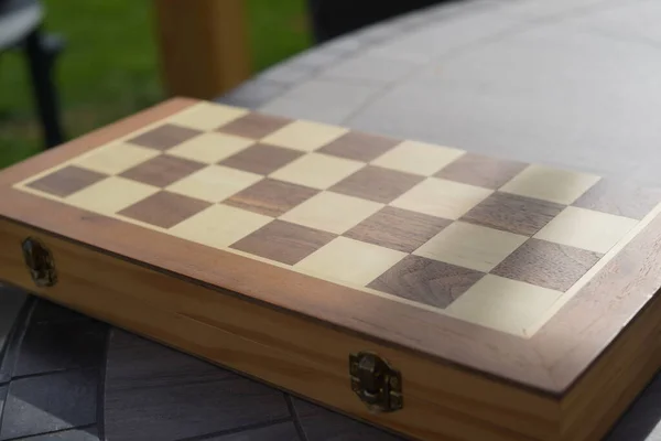 Chess board playing in outdoor location, chess board on tree stump