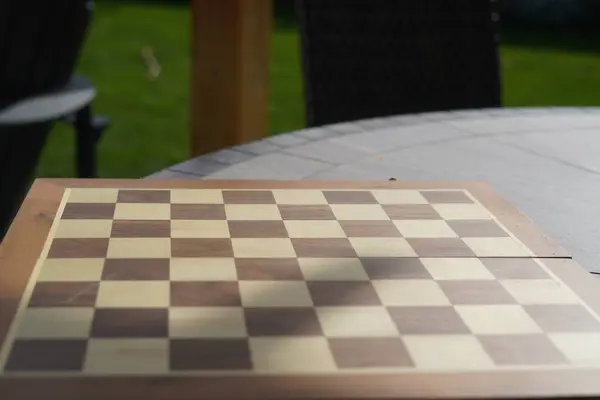 Chess board playing in outdoor location, chess board on tree stump