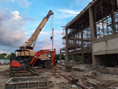 Photo of a construction site with cranes and backhoes. clipart