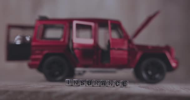 Die Aufschrift Versicherung Auf Würfeln Der Nähe Des Roten Autos — Stockvideo