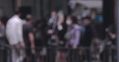 Büyük gürültülü bir şehirde, yavaş çekimde insanların bulanık hareketi