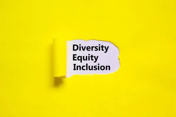 Diversity, equity, inclusion DEI symbol. Words DEI, diversity, equity, inclusion appearing behind torn yellow paper. Pink background. Business, diversity, equity, inclusion concept, copy space