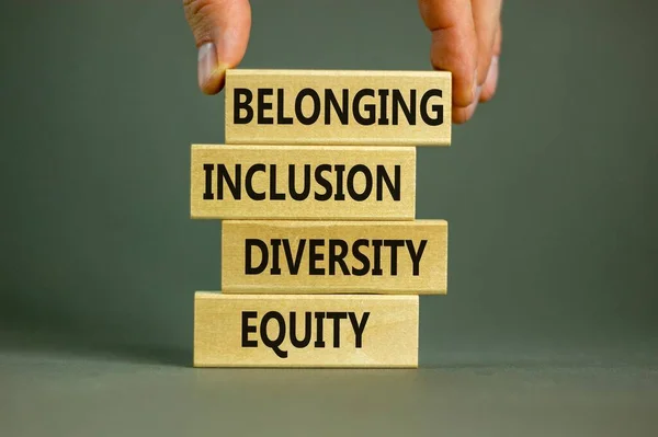 Equity, diversity, inclusion and belonging symbol. Wooden blocks with words \'equity, diversity, inclusion, belonging\' on beautiful grey background. Diversity, equity, inclusion and belonging concept