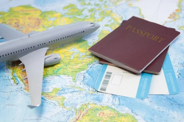 Boarding pass, passport, plane on the map