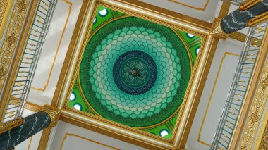 Zarif İslami mimari, parlak yeşil ve sarı bir kubbeye sahiptir. Simetrik alçak açılı çekimde mükemmel bir şekilde yakalanmıştır..